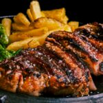 A steak and fries on a plate with a fork