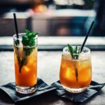 Two Brown Liquid Inside Clear Drinking Glasses