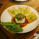 A plate of food with bread and greens on it