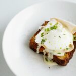 Brown Bread With White Cream and Green Vegetable on White Ceramic Plate